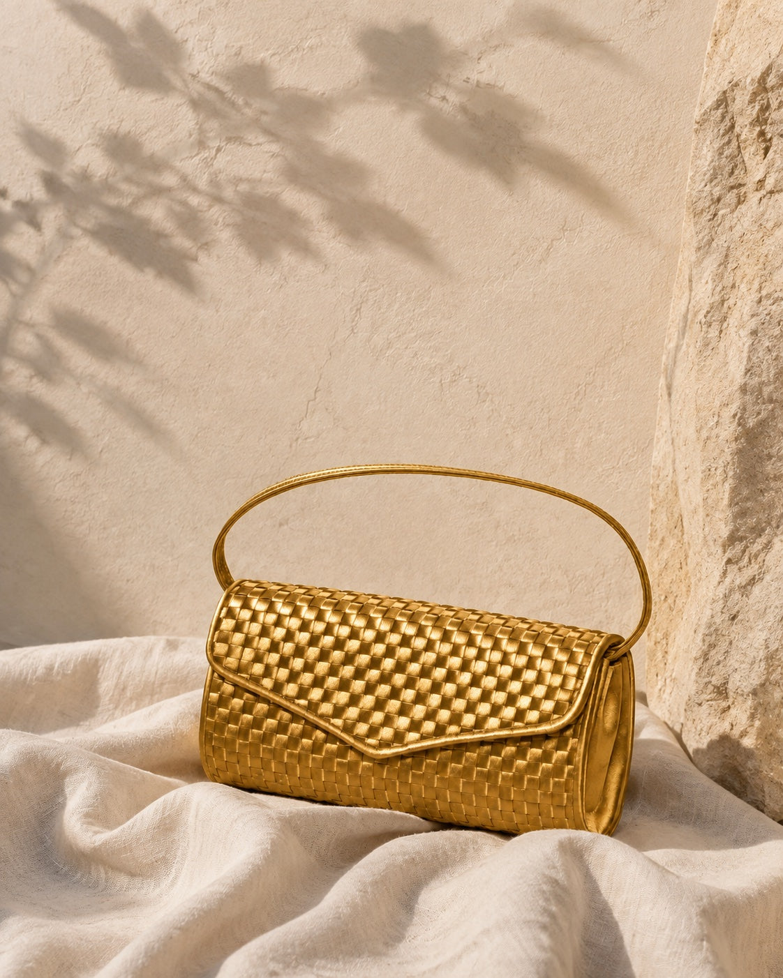 Rich Gold Signature handbag on linen in natural light