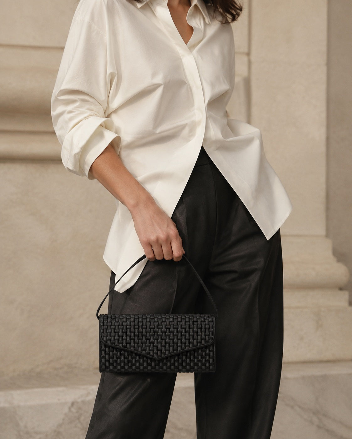 Essential Black Signature handbag styled with ivory and tailored trousers